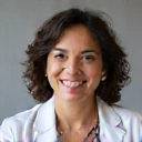 Professional portrait of Dr. Anya Sharma, a warm and knowledgeable dermatologist with a background in botanical medicine, smiling confidently.