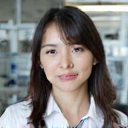Professional portrait of Sarah Lee, a biochemical engineer with a keen analytical mind, looking innovative and focused in a modern lab setting.
